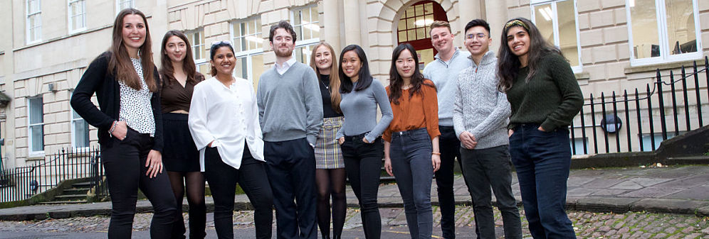 group of smiling law students outside of law building